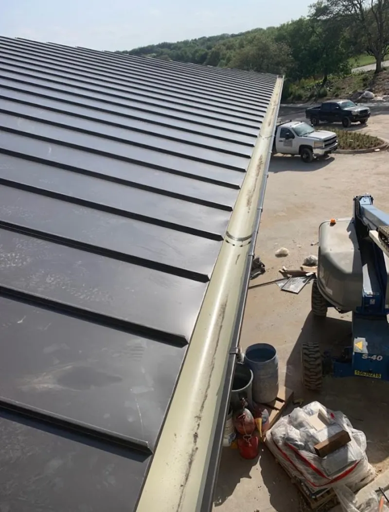 Standing seam panel and gutter detail on a metal roofing jobsite in Hillsborough